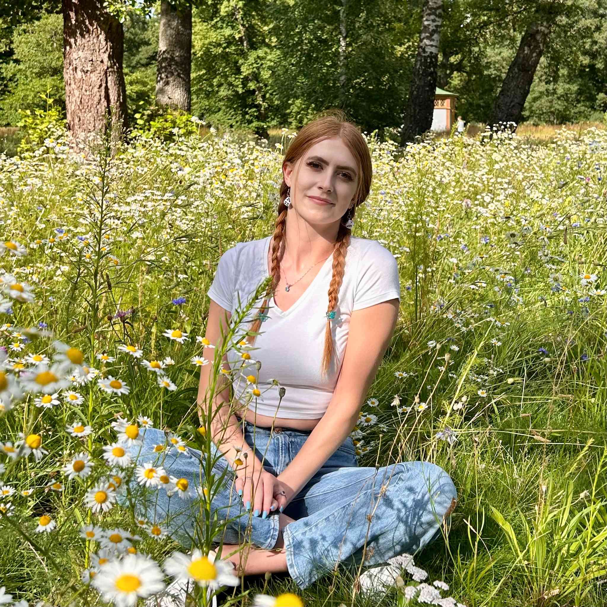 Author portrait outdoors in a wildflower meadow.